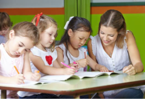 Child practising handwriting with a paediatric occupational therapist