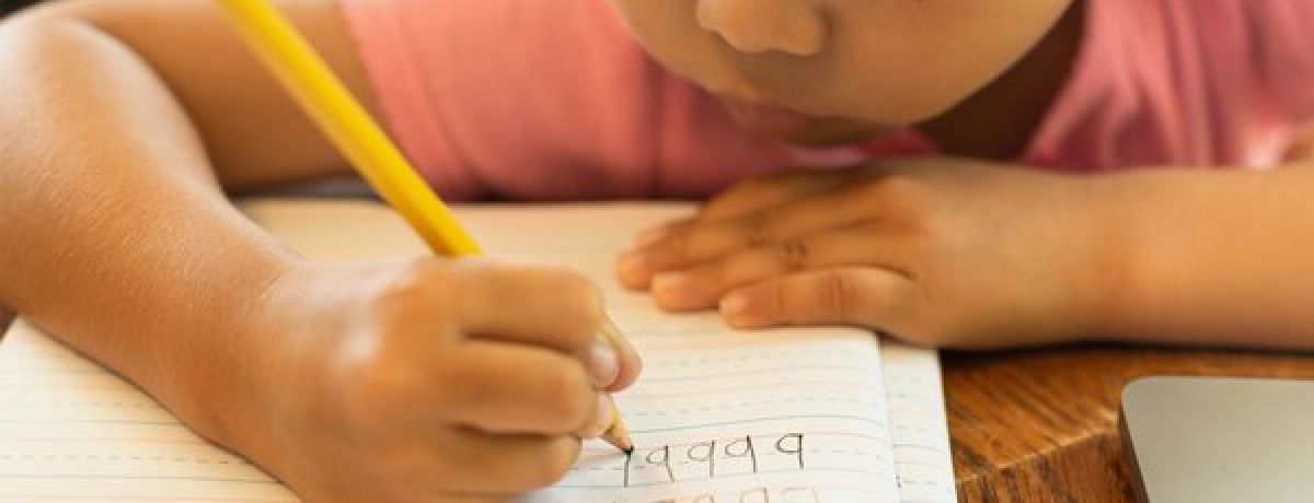 Child practising handwriting with a paediatric occupational therapist